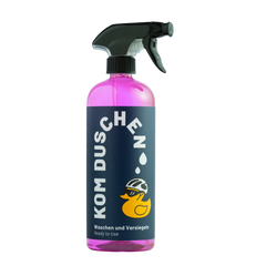 Eine rosa Sprühflasche mit dem Produkt Waschen und Versiegeln – Ready to Use von KOM Duschen GmbH, versehen mit einem Etikett, auf dem eine Gummiente mit Fahrradhelm abgebildet ist.